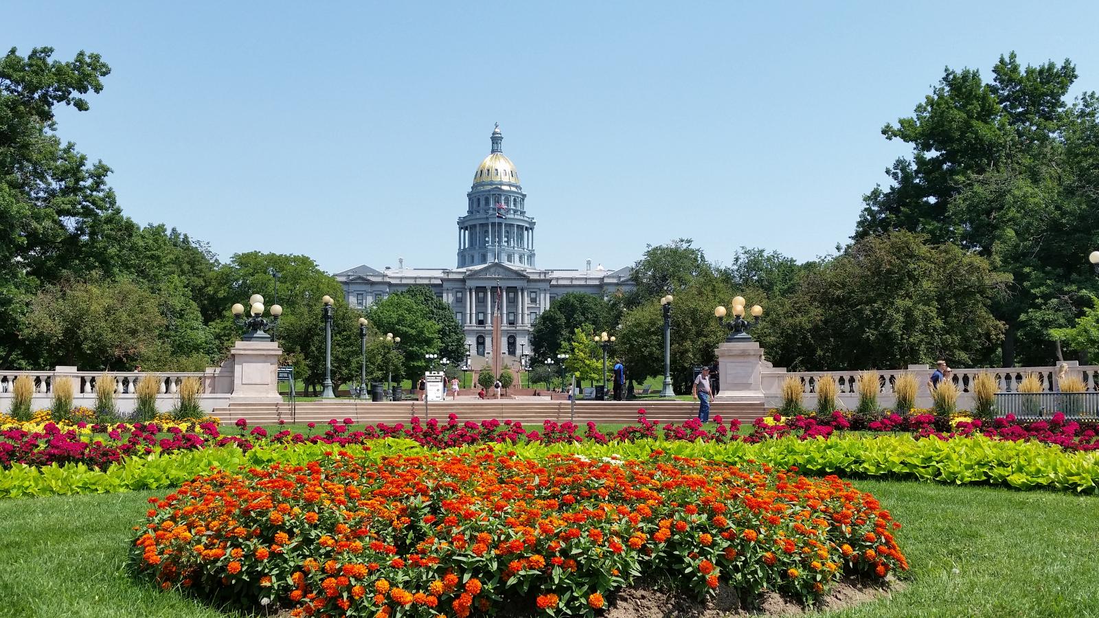 capitol building from a distance with flower garden in foreground